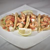 Tacos de Camaron · Shrimp tacos. Soft, corn tortilla, with shrimp, our secret salsa, chopped onions, garnished ...