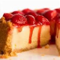 Slice of NY Cheesecake with Strawberries · Rich creamy cake. 