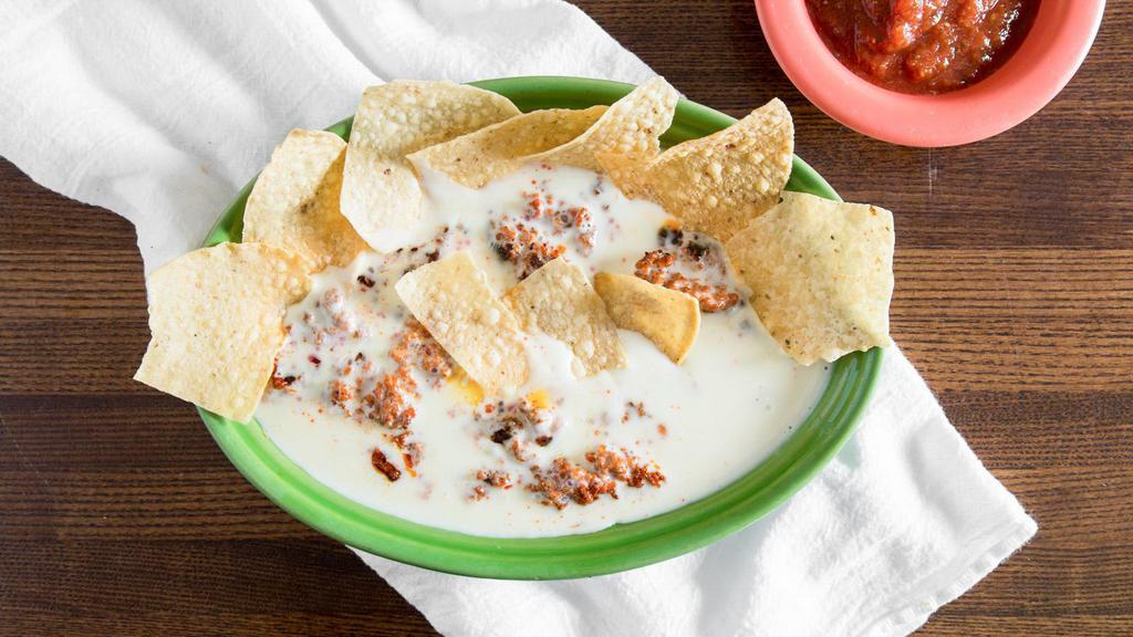 Chorizo Dip · Grilled Mexican chorizo sausage thrown in  our flavourful authentic white cheese dip.