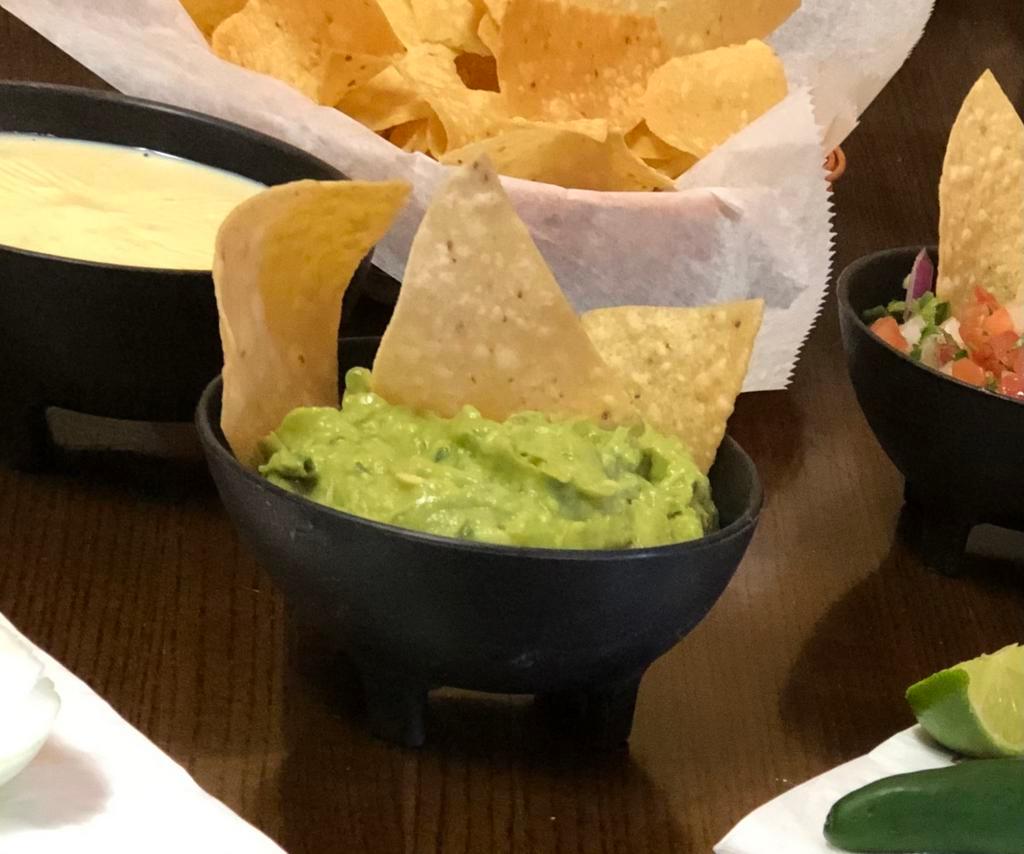 Guacamole Dip & Chips · A delightful mix of fresh avocado, onion and tomato with a hint of cilantro and jalapeno - Homemade