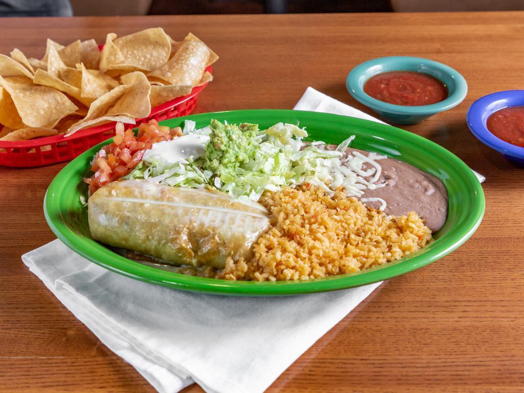 Chimichanga · A large flour tortilla filled with your choice of beef tips, ground beef, or shredded chicken, wrapped up and deep fried, then covered with white cheese dip. Served with guacamole salad, sour cream, rice & beans.