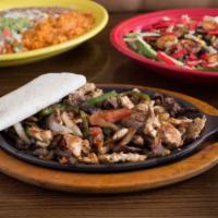 Pork Fajitas · Chunks of tender pork grilled with baby red potato, red onion, red and yellow peppers. Serve...