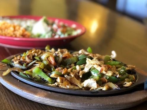 Chicken Fajita · Chicken grilled with bell peppers, tomatoes, and onions. Served with rice, beans, pico, guacamole, sour cream, lettuce, and tortillas.