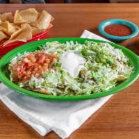 Full Order Nachos Supreme · A bed if crispy tortilla chips, smother with our flavorful white cheese dip, topped with chi...
