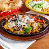 Pollo Fundido · Grilled chicken and shrimp cooked with mushrooms and peppers. Topped with cheese and served ...