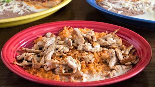 Pollo Cheese Dip · Grilled chicken over rice topped with our unique white cheese sauce.