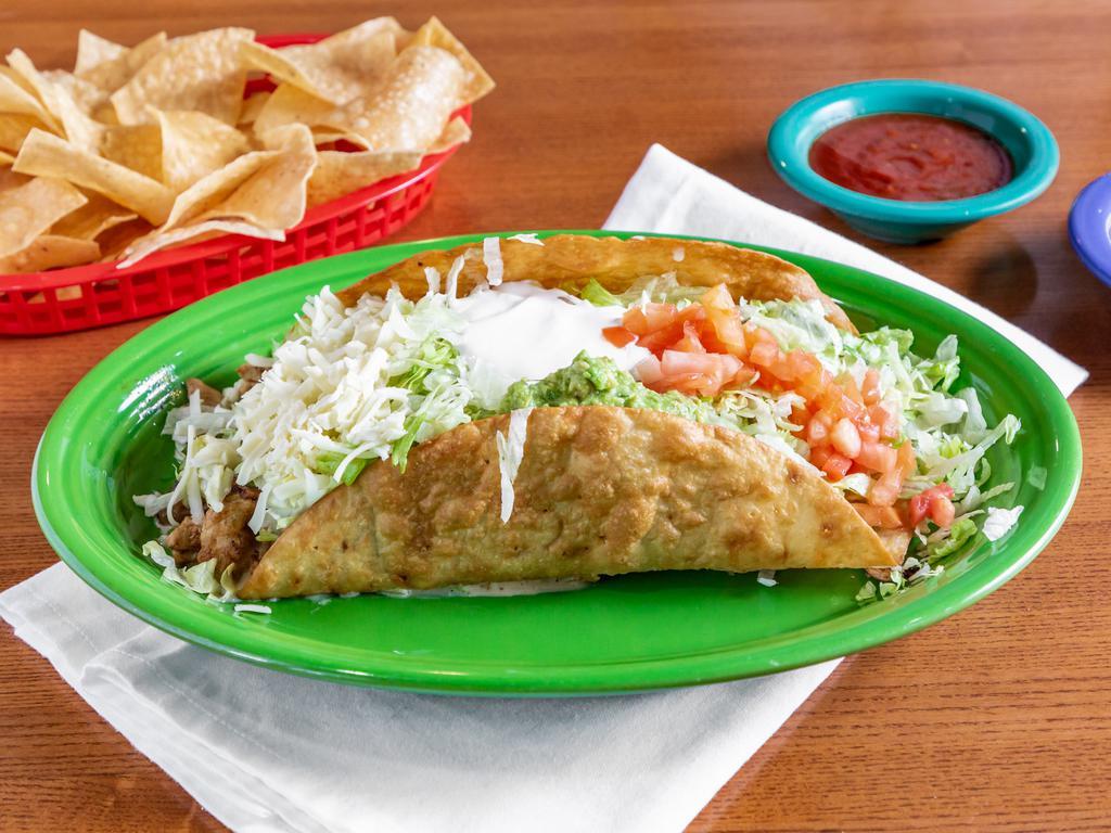 Taco Salad Fajitas · A Large crispy flour Taco with melted cheese sauce topped with your choice of chicken or steak, and  sauteed with onions, bell peppers, and tomatoes covered with lettuce, cheese, sour cream and guacamole