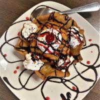 Signature Fried Ice Cream · Vanilla ice cream covered in frosted flakes, slightly deep fried, drenched in Honey, chocola...