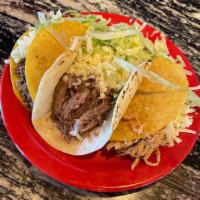 Taco · A corn hard shell or soft flour shell filled with ground beef, shredded chicken, or pork top...