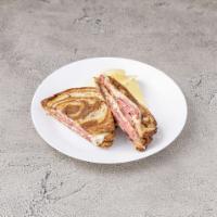 Reuben Panini · Grilled sandwich with juicy corned beef, sauerkraut, Russian dressing and Swiss cheese on ry...
