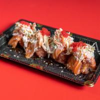 Lady Bug · 4 pieces of crunchy rice wrapped with salmon . Topping crab salad, topiko red and spicy mayo.