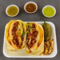 Al Pastor Tortas · Fluffy Bun Bread With Al Pastor Meat, Beans, Cheese, Lettuce, Tomato And Avocado. 