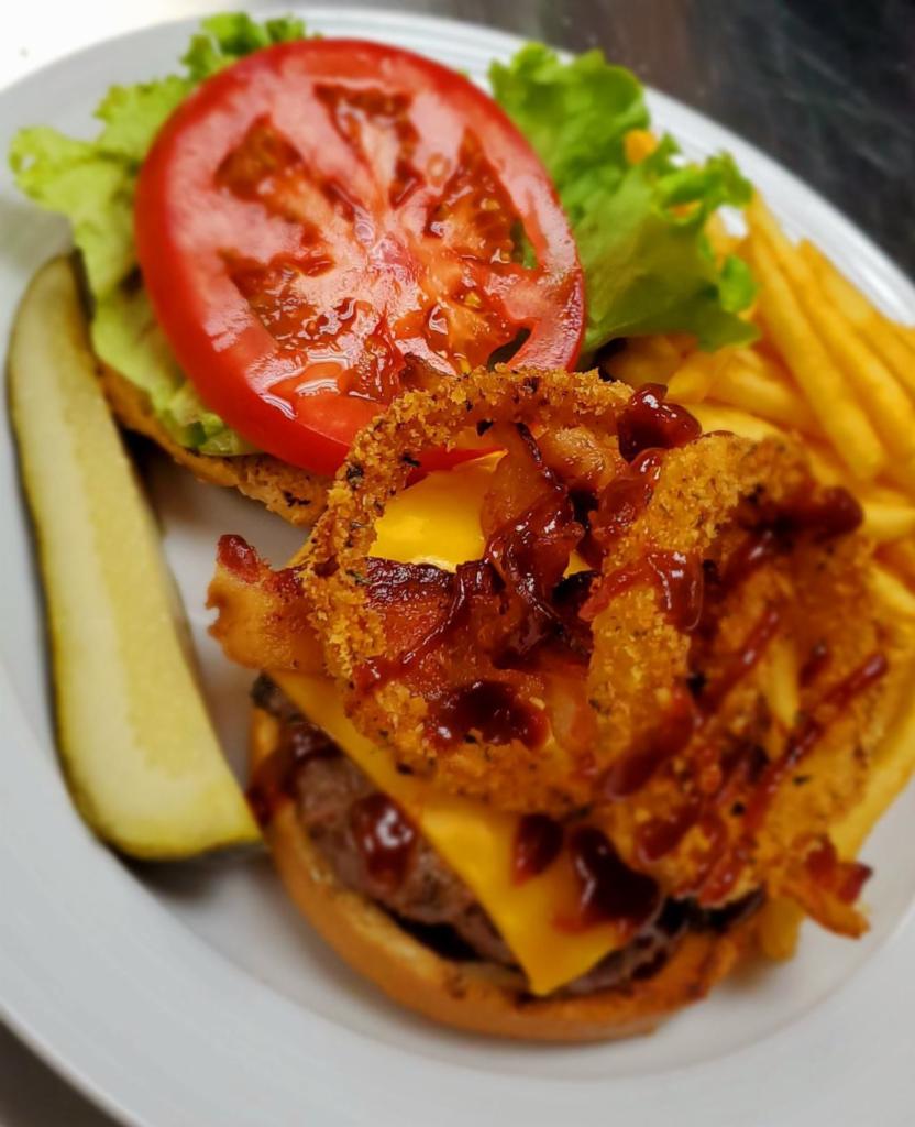 BBQ Bacon Burger · 6 oz. patty served with American cheese, onion rings, tomatoes and lettuce on toasted sesame bun.
