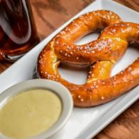 Pretzel · Soft toasted pretzel, choice of jalapeno cheese or house queso.