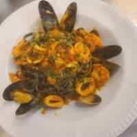 **Linguini Fruit di Mare · Squid ink linguini, mussels, clams, shrimp, calamari, bay scallops, garlic and San Marzano c...