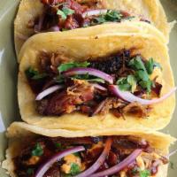 Baja Pork Taco · Crispy pork, bacon, grilled cheddar jack, chipotle aioli, Smokey citrus glaze, red onion and...