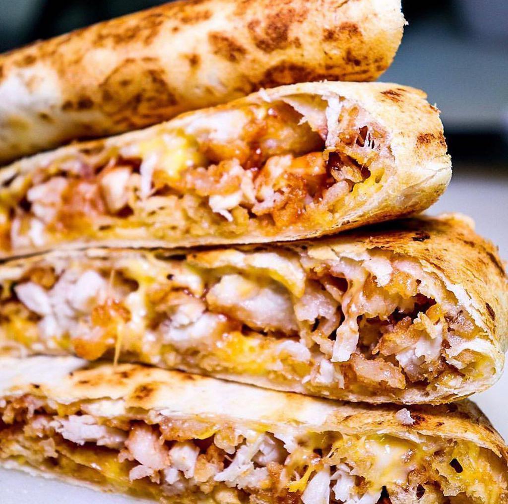 BBQ Chicken Quesadilla · One large flour tortilla, stuffed with grilled chicken, cheese, BBQ sauce, crispy onions, and green sauce.