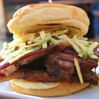 Brisket Sandwich · Smoked brisket on Brioche Buns topped with BBQ, green sauce, and potato sticks. Served with ...