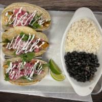 Baja Chicken Tacos · Spiced Chicken, pickled red onion, shredded lettuce, queso fresco, lime crema & cilantro. Se...