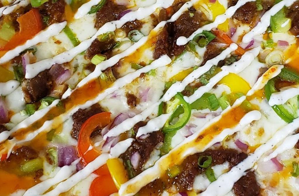 Pizzogi Pizza (Korean) · Marinated steak, bell pepper medley, red onions, jalapenos, scallions, drizzled with chili garlic aioli.