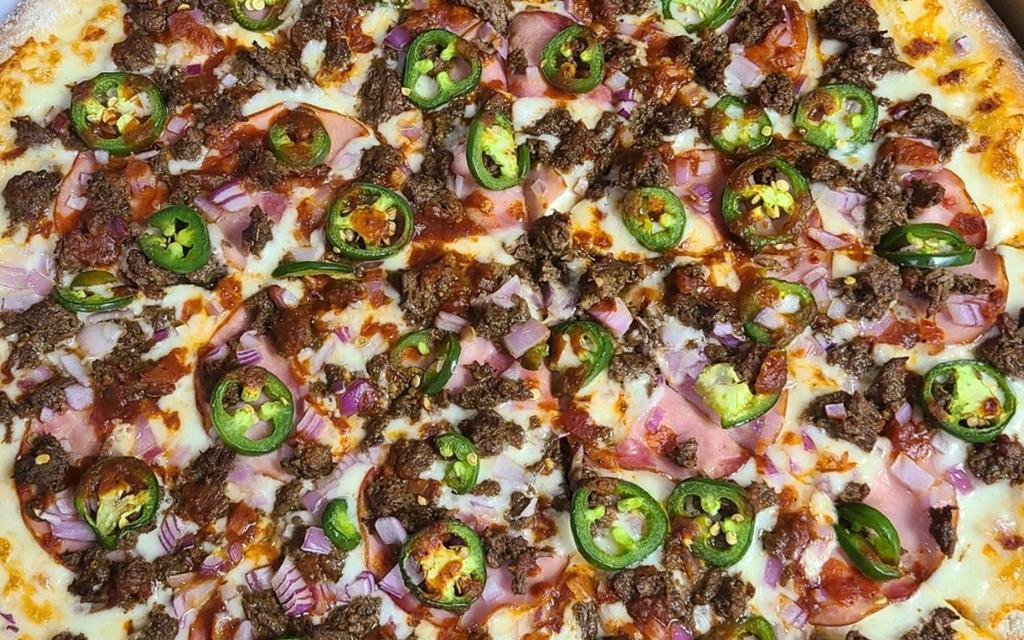 Barbacoa Pizza (Mexican) · Smoked spiced and slow-cooked shredded beef, Canadian bacon, custom blend cheeses, red onions, jalapenos.