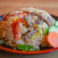 Thai Fried Rice · Thai style fried rice with onions, tomatoes, scallions and egg.