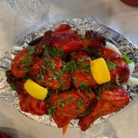 26. Tandoori Chicken · Chicken leg and thigh portion marinated in yoghurt with freshly ground spices and lemon juic...