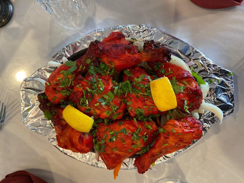 26. Tandoori Chicken · Chicken leg and thigh portion marinated in yoghurt with freshly ground spices and lemon juice. Does not include rice and naan.