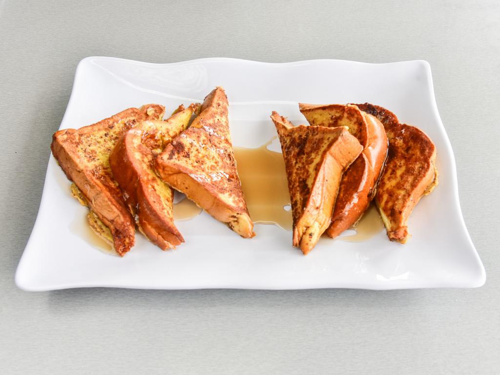 Challah French Toast · Three golden slices cut in 1/2 dusted with confectionary sugar, cooked with eggs, cinnamon powder, sugar and maple syrup.