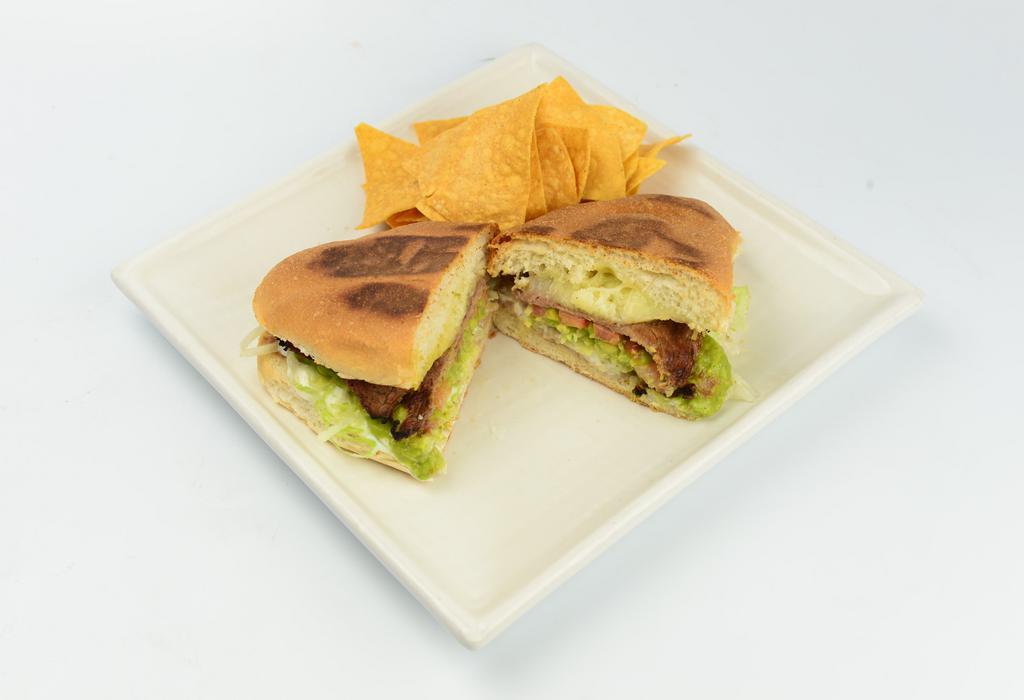 Torta · Toasted Mexican bread with choice of meat, refried beans, cheese, sour cream, tomato, lettuce and guacamole. 