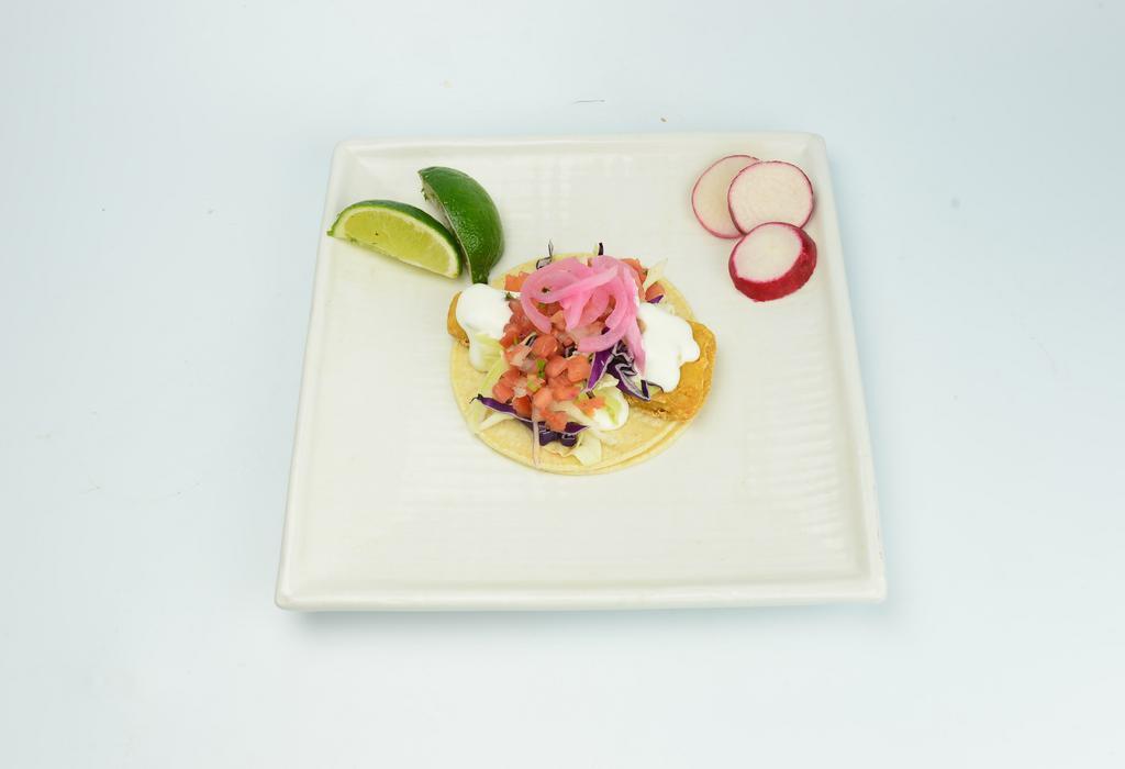 Fried Fish Taco · Corn tortillas, red and green cabbage, sour cream and fresh salsa. 