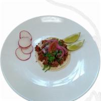 Regular Beyond Vegan taco · Corn tortillas, beyond meat, taco sauce, cilantro, onion 