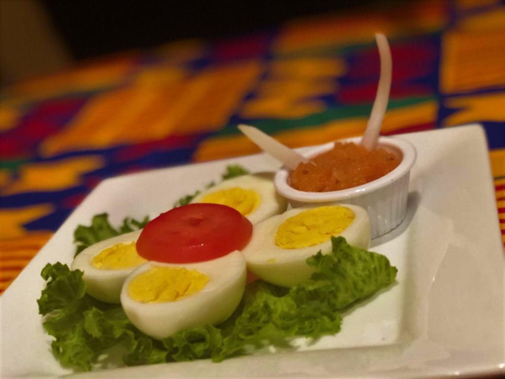 Spicy African Deviled Eggs · Served with hot sauce.