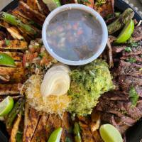 Fiesta fajita platter  · Feeds up to seven people,  steak Chichen , rice and beans with tortillas as well 