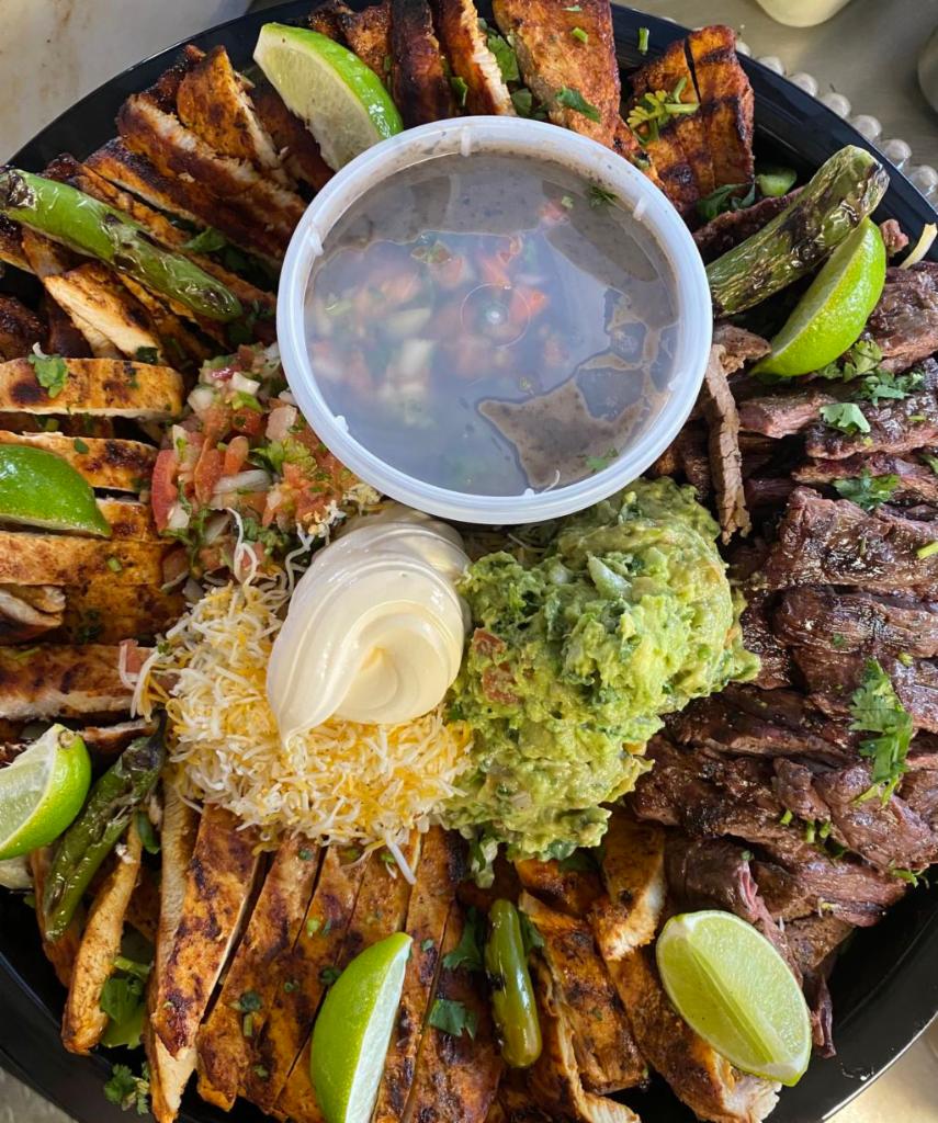 Fiesta fajita platter  · Feeds up to seven people,  steak Chichen , rice and beans with tortillas as well 