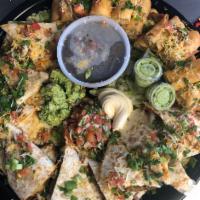 Tortilla platter  · Mix of quesadillas , and flautas platters feed up seven people .chicken &steak 