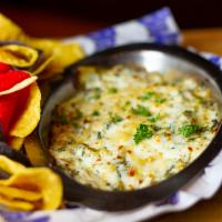 Spinach and Artichoke Dip · Spinach, artichoke hearts and loads of cheese, warm tortilla chips on the side.