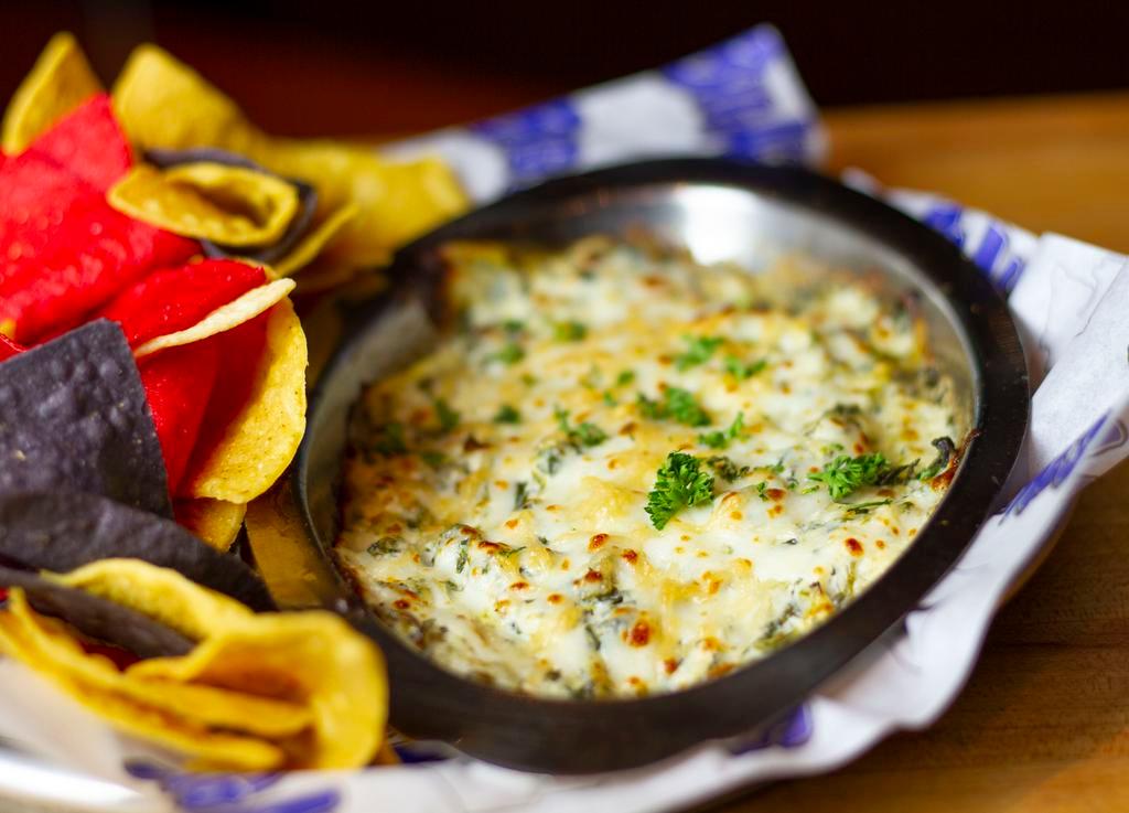 Spinach and Artichoke Dip · Spinach, artichoke hearts and loads of cheese, warm tortilla chips on the side.