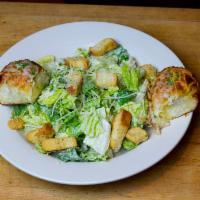 Caesar Salad · Romaine lettuce, Parmesan cheese, Caesar dressing, cheesy butter rolls. 