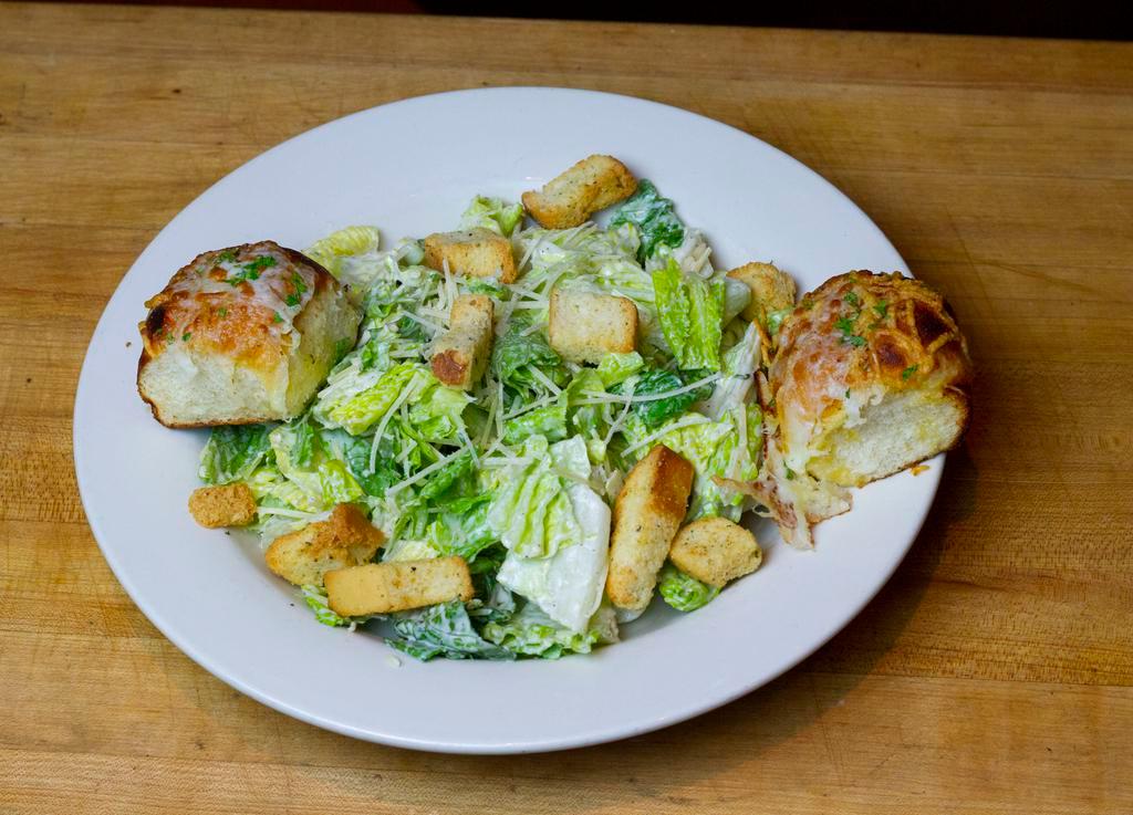 Caesar Salad · Romaine lettuce, Parmesan cheese, Caesar dressing, cheesy butter rolls. 
