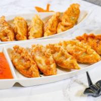 Chicken Gyoza · 5 pcs of deep-fried chicken dumplings served with sweet chili sauce.