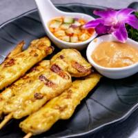Chicken Satay · 4 pieces. Strips of chicken marinated in coconut milk and grilled on skewer, served with pea...