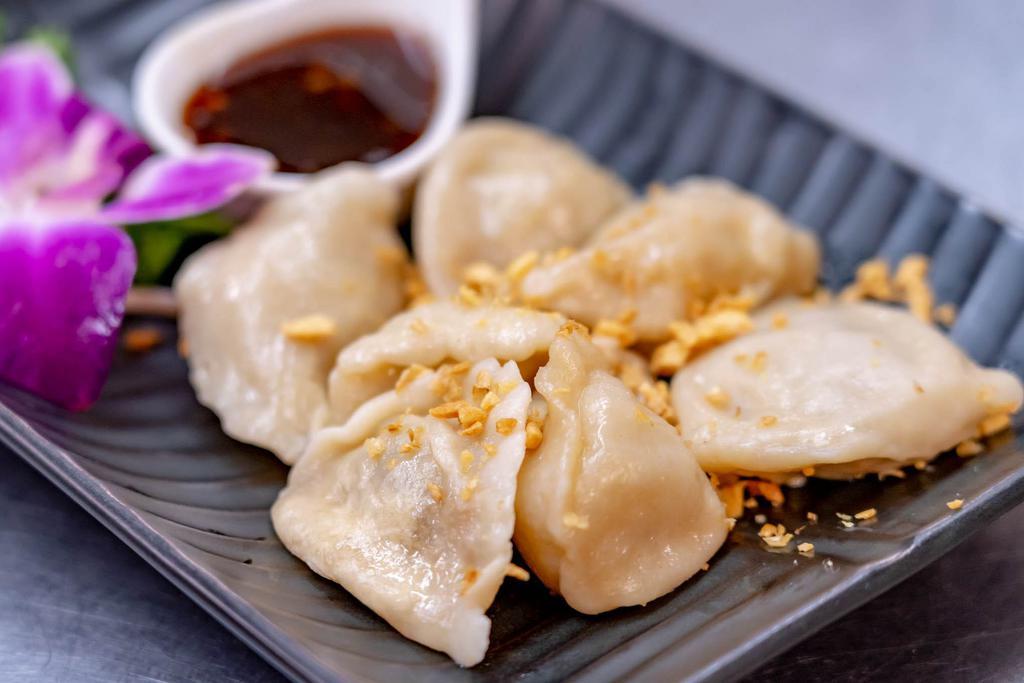Dumpling · 7 pieces. Steamed or fried pork filing and served with ginger sauce. 
