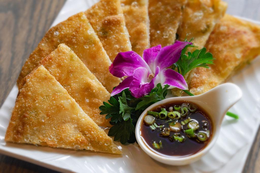 Scallion Pancake · Wheat flour stuffed with scallions and herbs, deep-fried and served with ginger sauce.