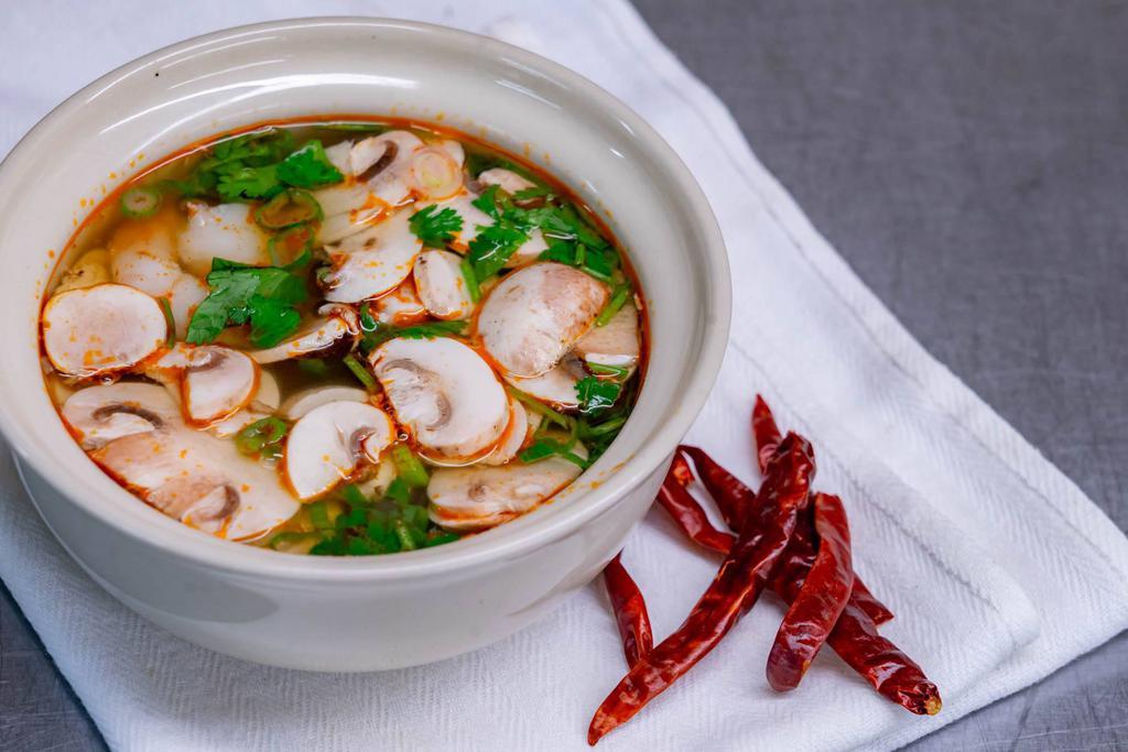 Tom Yum Soup  · Chicken, shrimp or veggie. Famous hot and sour soup with chili paste, Thai herbs, lemon grass, lime juice and mushrooms, topped with scallions and cilantro. Spicy.