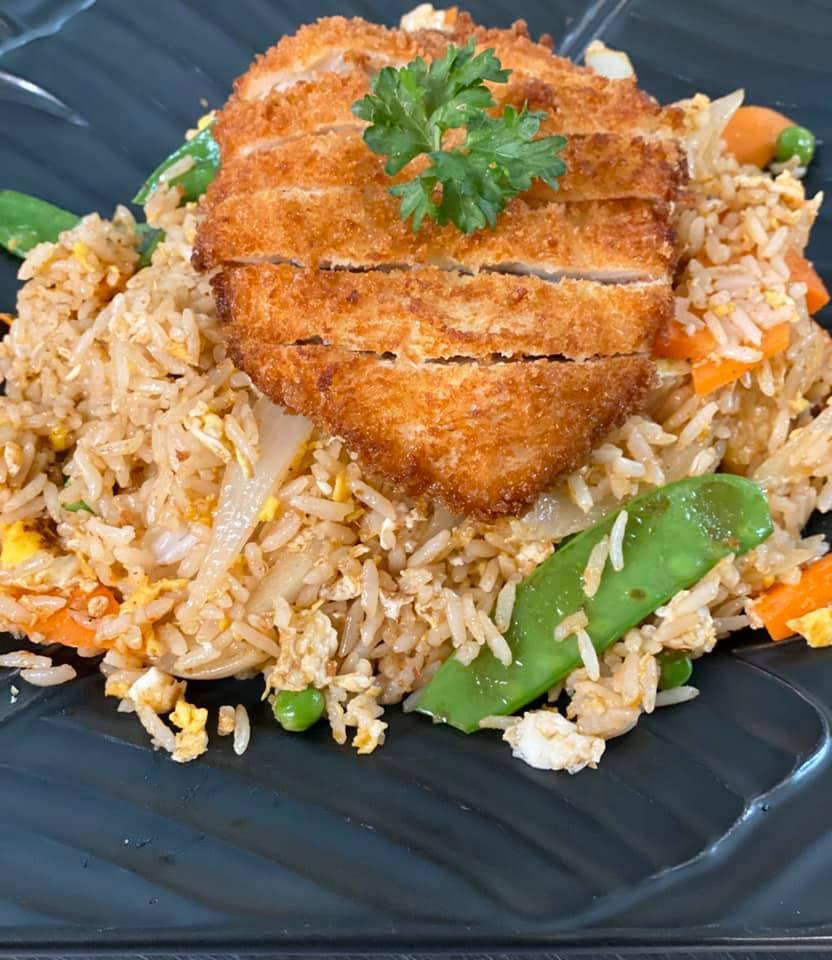 Crispy Chicken Fried Rice · Fried rice with crispy chicken, egg, onions, snow peas, green peas, carrots and chili paste. Spicy.