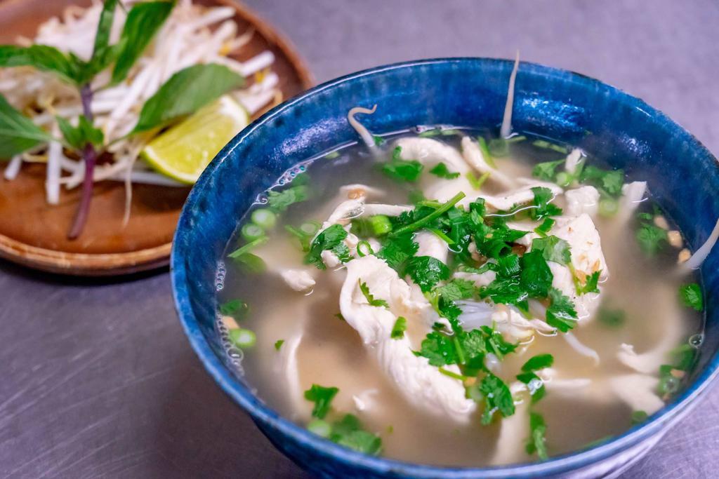 Pho Chicken Noodle Soup · Rice noodles with chicken, bean sprouts, basil leaves and garnish with scallions and cilantro in chicken broth.