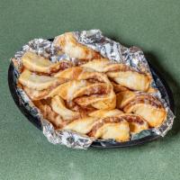 Cinnamon Twists · Our famous twists rolled with a brown and white sugar-cinnamon mixture and topped with a del...