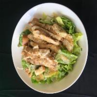 Grilled Chicken Caesar Salad · Crisp romaine lettuce, homemade seasoned croutons, and imported Parmesan topped with our sig...