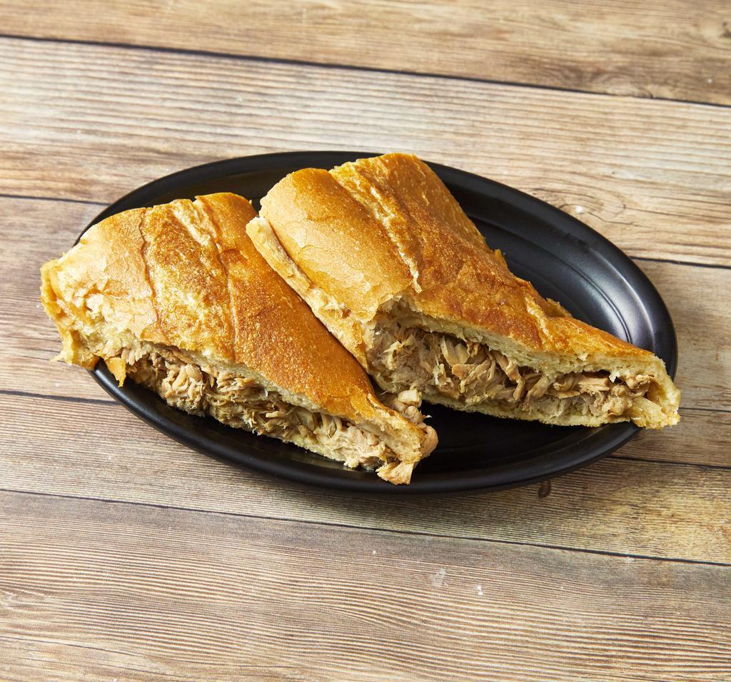 Sandwich de Lechon Asado · Roasted pulled pork sandwich with Cuban seasonings.